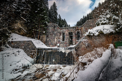 Avalanche barrier with a small stream and mountains in the background.Axams,Austria.2021 photo