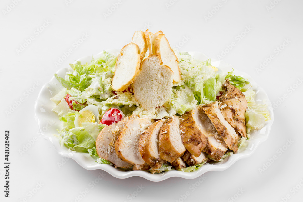 Isolated russian style caesar chicken salad on the white background Isolated russian style caesar chicken salad on the white background