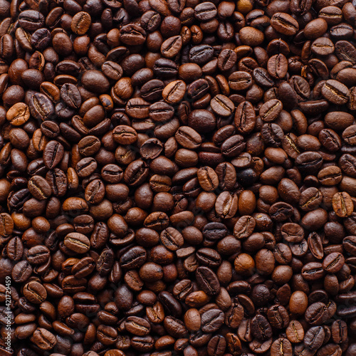 Roasted coffee beans background. Top view, square