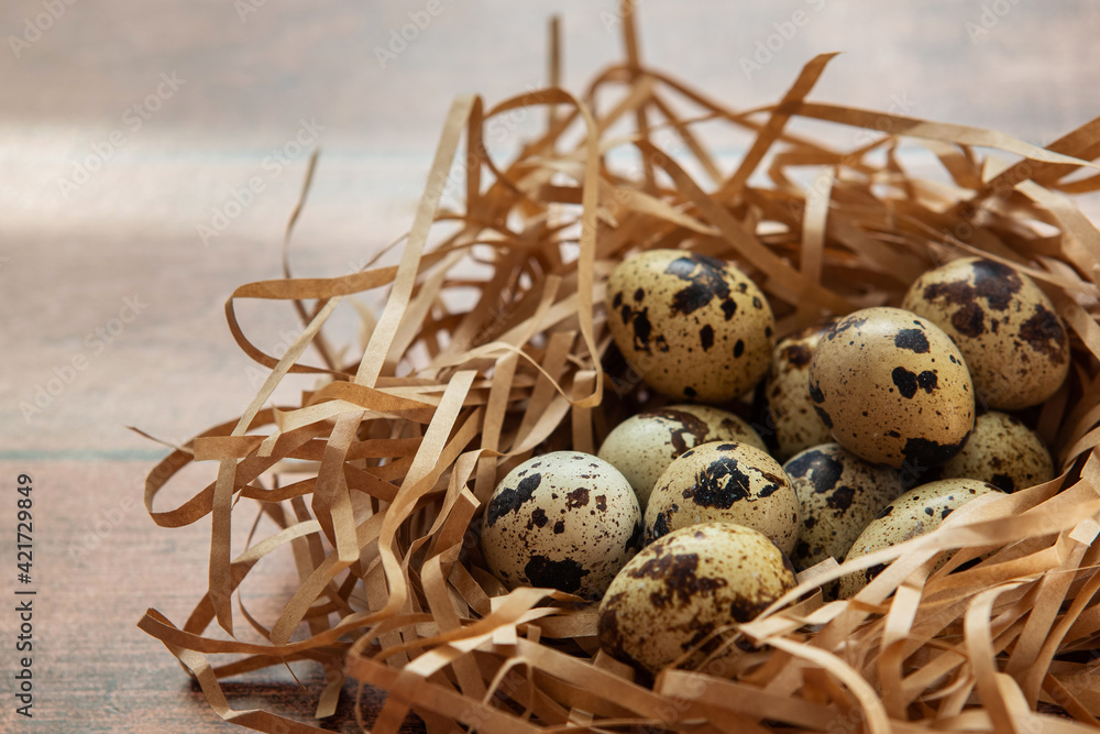 Small quail eggs on wooden background. Happy Easter background. Small quail eggs on wooden background. Happy Easter background.