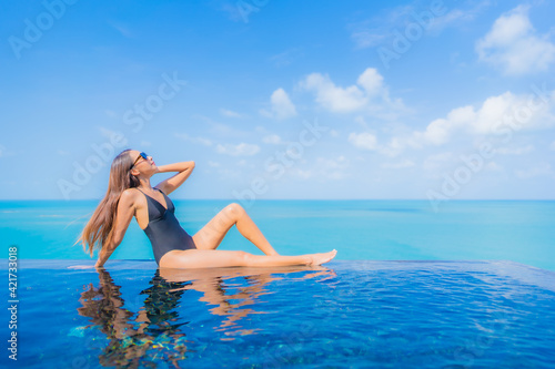 Portrait beautiful young asian woman relax smile leisure around outdoor swimming pool