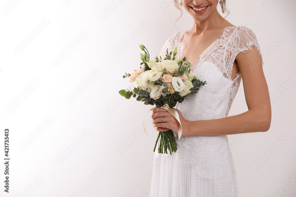 Naklejka premium Young bride with beautiful wedding bouquet on white background, closeup. Space for text