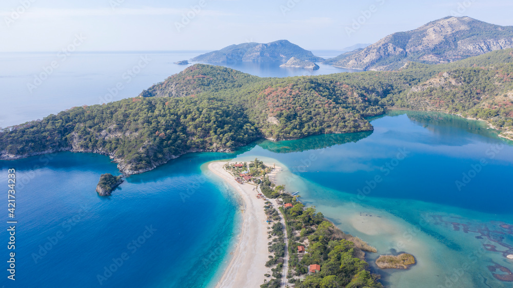 Panoramic and vivid shot of Oludeniz, also known as Blue Lagoon, in Fethiye. It is located on south-west of Turkey and it has been a tourist attraction with its blue sea, weather and coast.