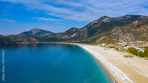 Panoramic and vivid shot of Oludeniz, also known as Blue Lagoon, in Fethiye. It is located on south-west of Turkey and it has been a tourist attraction with its blue sea, weather and coast.