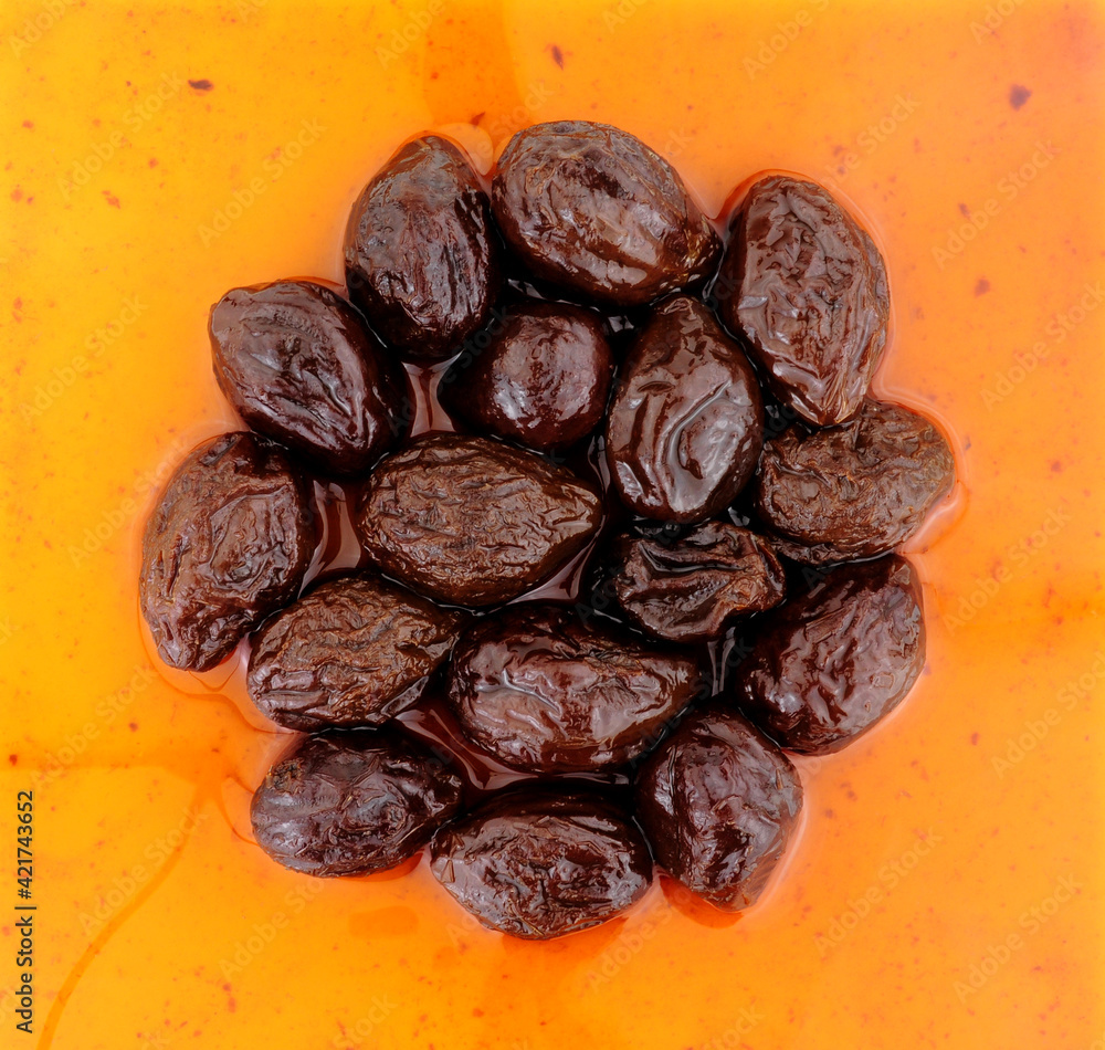 Obraz premium Prunes in juice made from dried plumb fruits high fibre healthy food ingredient