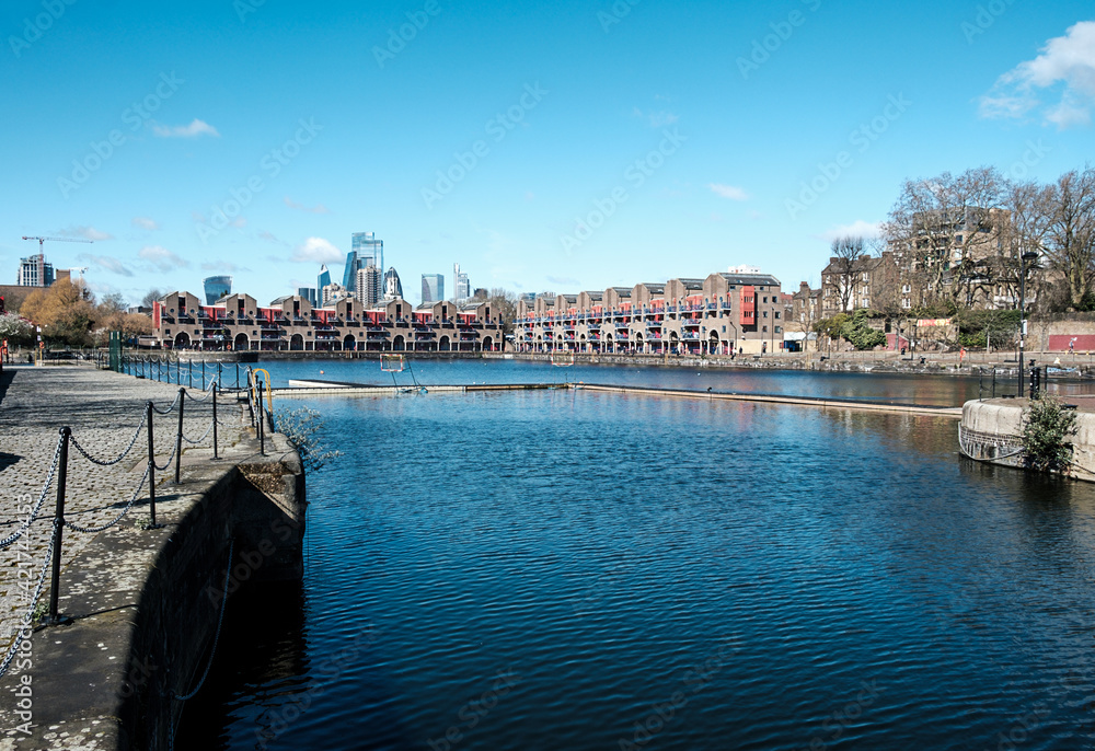 Shadwell basin, London, in a beautiful spring morning. City buildings on the background.