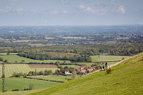 People waking over the rolling Sussex countryside near Brighton