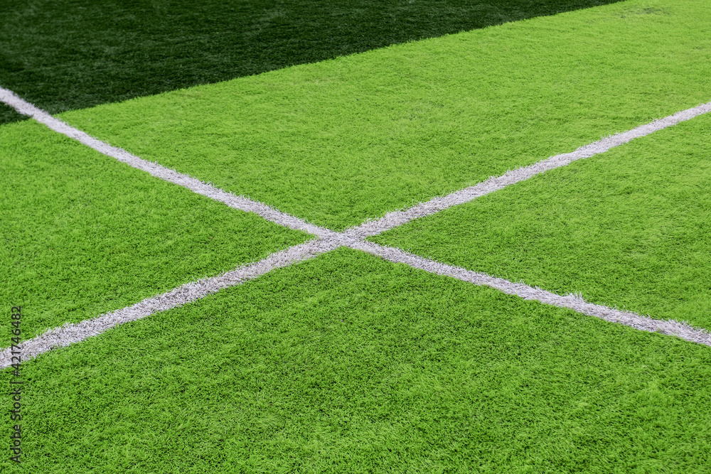 Artificial green grass on a professional soccer field. Outdoor artificial soccer field awaiting players' exit