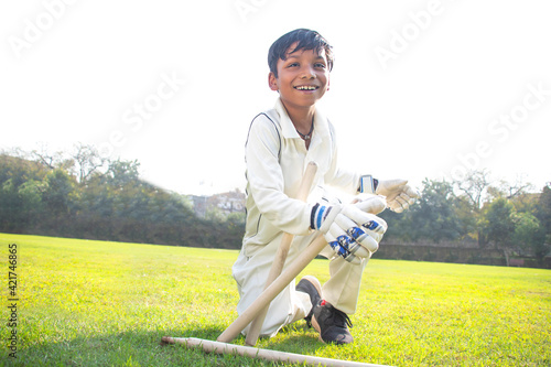 Photography a boy wicket keeper stumping during cricket game