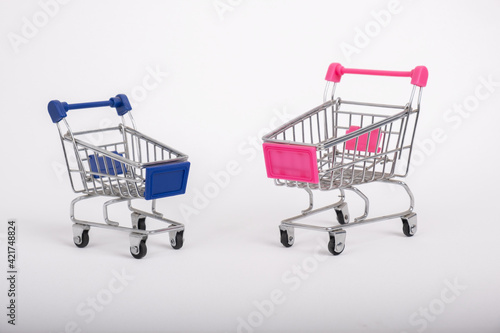 Two toy Shopping Carts on white backgrounds.