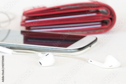 mobile phone with earphone and red purse of liestyle woman arrangement flat lay style on background white