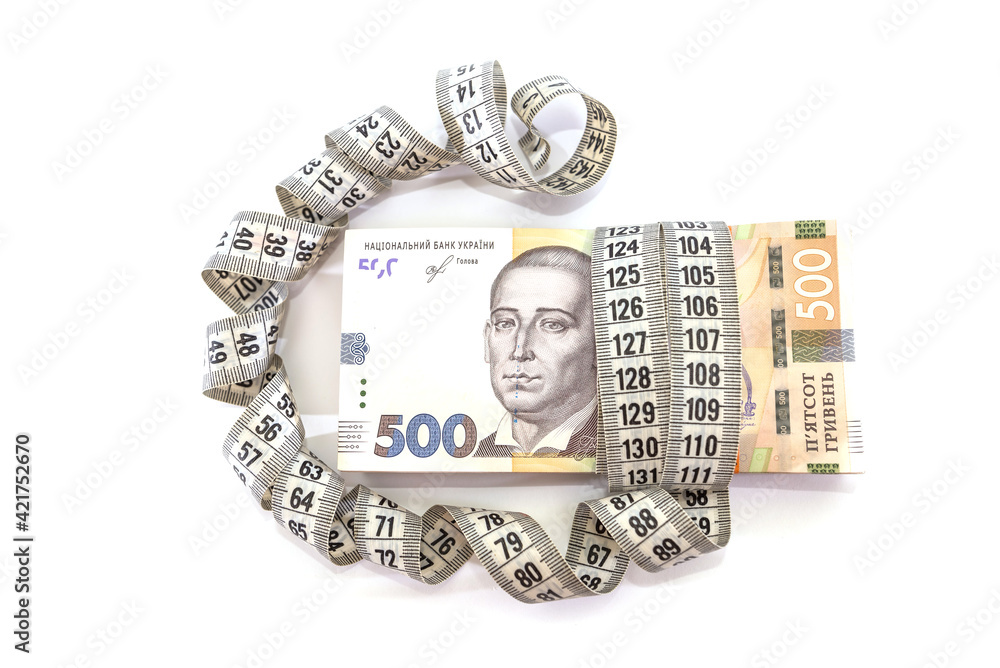 500 hryvnia with measuring tape on white 500 hryvnia with measuring tape on white