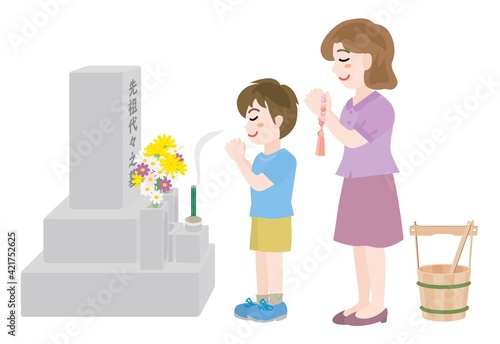 お墓参りをする母と息子