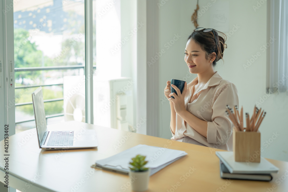 Businesswoman having tea or coffee in home office. Businesswoman having tea or coffee in home office.
