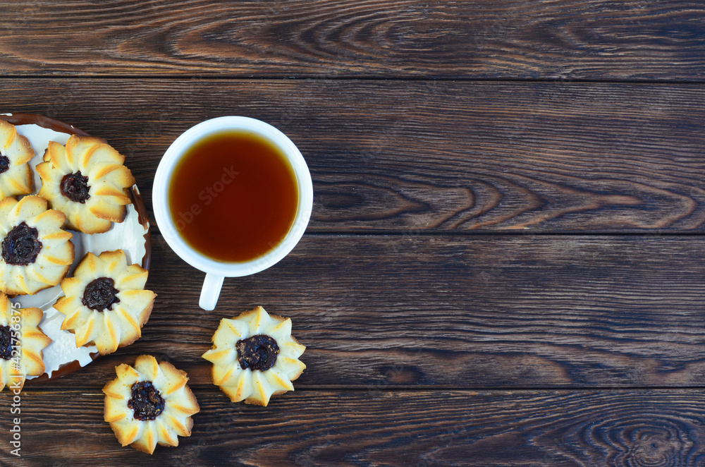 homemade shortbread cookies kurabye and a cup of tea on a textured wooden table top view homemade shortbread cookies kurabye and a cup of tea on a textured wooden table top view