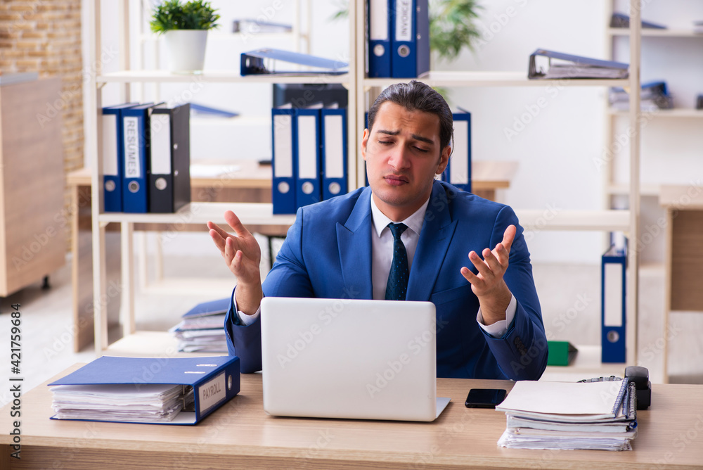 Young handsome employee sitting in the office Young handsome employee sitting in the office