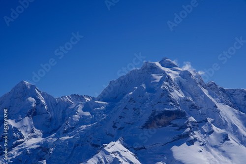 Panorama of Bernese Alps with Mountain Peaks Mönch (monk) and Jungfrau (virgin), seen from Mürren, Switzerland. © Michael Derrer Fuchs
