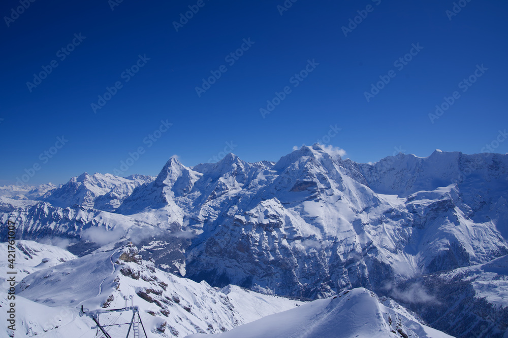 Panorama of Bernese Alps with Mountain Peaks Eiger, Mönch (monk) and Jungfrau (virgin), seen from Mürren, Switzerland. Panorama of Bernese Alps with Mountain Peaks Eiger, Mönch (monk) and Jungfrau (virgin), seen from Mürren, Switzerland.
