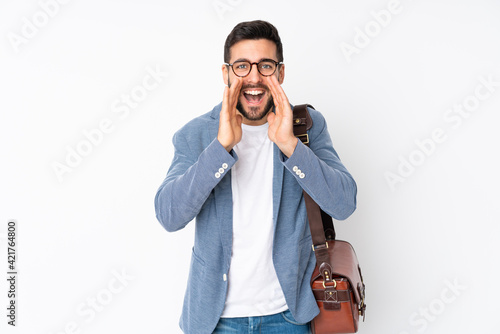 Caucasian business man isolated on white background shouting with mouth wide open