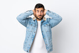 Young handsome man with beard isolated on white background frustrated and covering ears