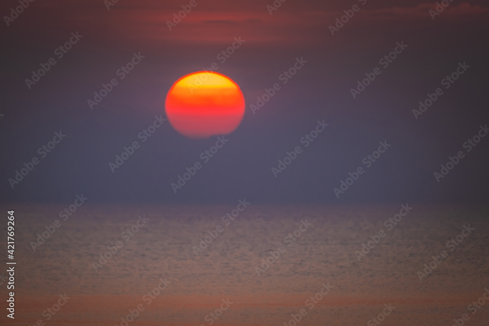 Beautiful of sunrise over the sea. Image blurred for wallpaper background.