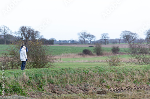 A unknown couple taking a walk through the beautiful Suffolk countryside on a cold winters day © Collins Photography