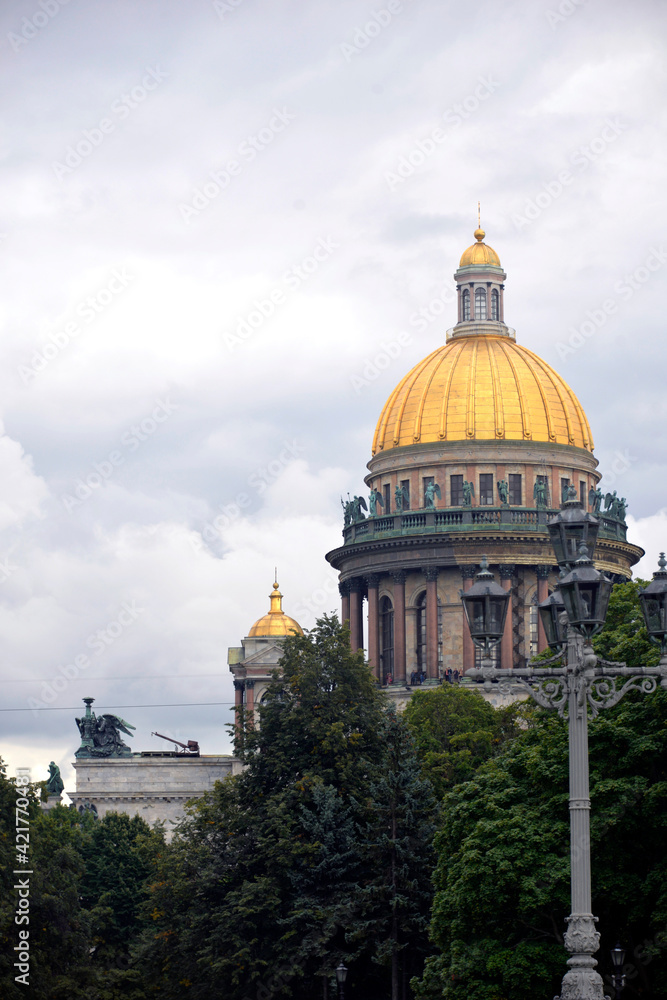 Russia. St. Petersburg. The golden dome of St. Isaac`s Cathedral against the background of the sky and clouds on a sun day. Tourism. Architecture. 