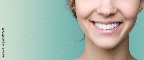 Beautiful smile of young woman with healthy white teeth photo