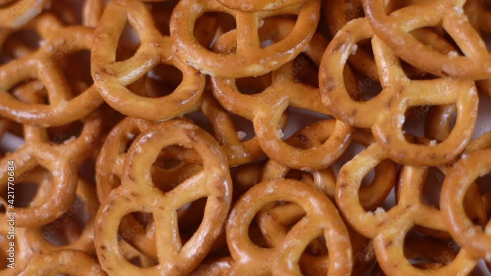 Close up of salted savory mini pretzels in the traditional looped knot shape. Top view. Rotation video Close up of salted savory mini pretzels in the traditional looped knot shape. Top view. Rotation video