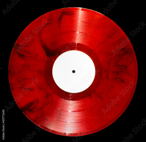 vinyl record of red color on a black background close-up