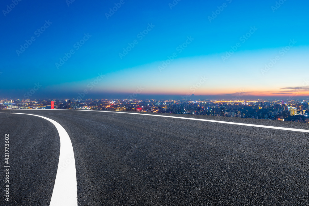 Fototapeta premium Empty asphalt road and Shanghai skyline with buildings at night.