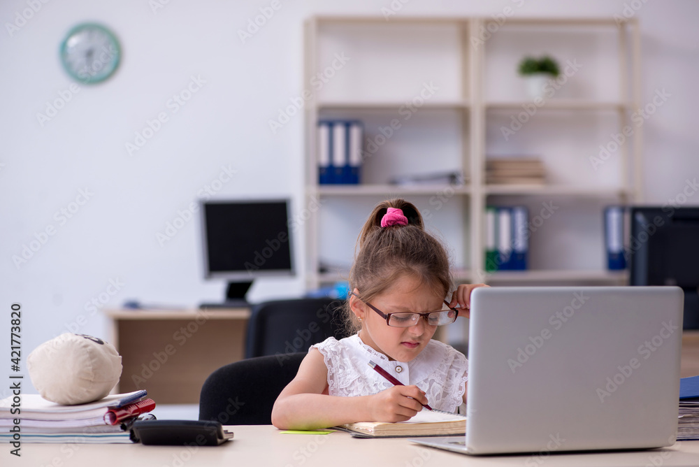 Funny small girl working in the office Funny small girl working in the office