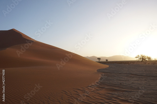 The red dunes of sossusvlei national park during sunset.