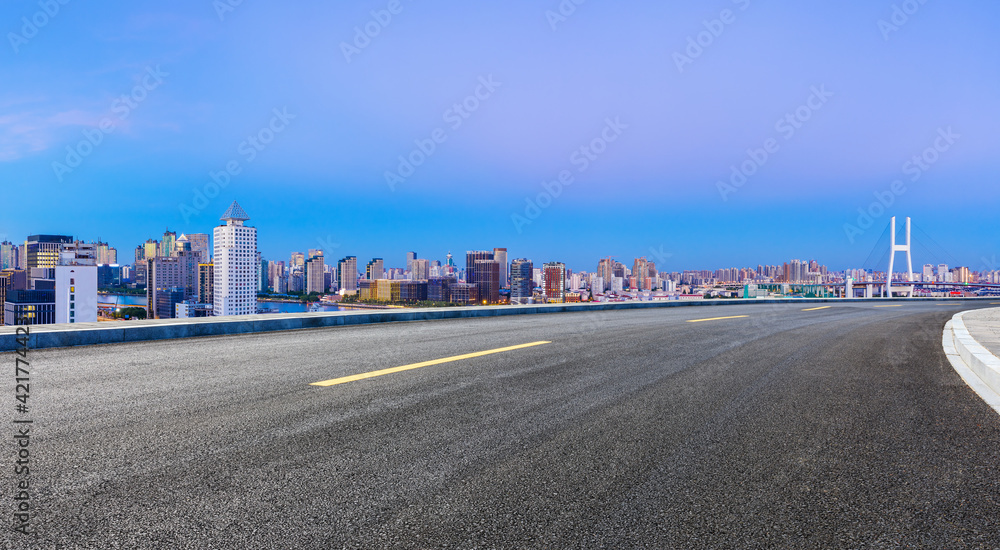 Asphalt highway and city skyline at night in Shanghai,China.
