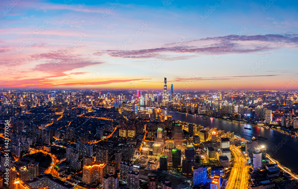 Aerial view of modern city skyline and buildings at night in Shanghai.