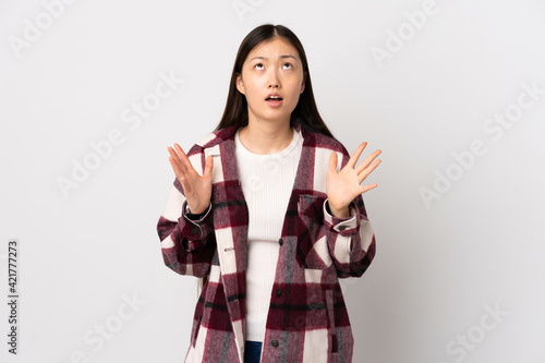 Young Chinese girl over isolated white background stressed overwhelmed © luismolinero