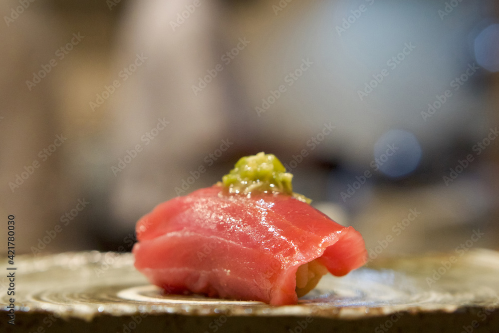 Tuna Sushi with fresh wasabi served on ceramic plate. Enjoy Omakase experience at Japanese Sushi Restaurant.
