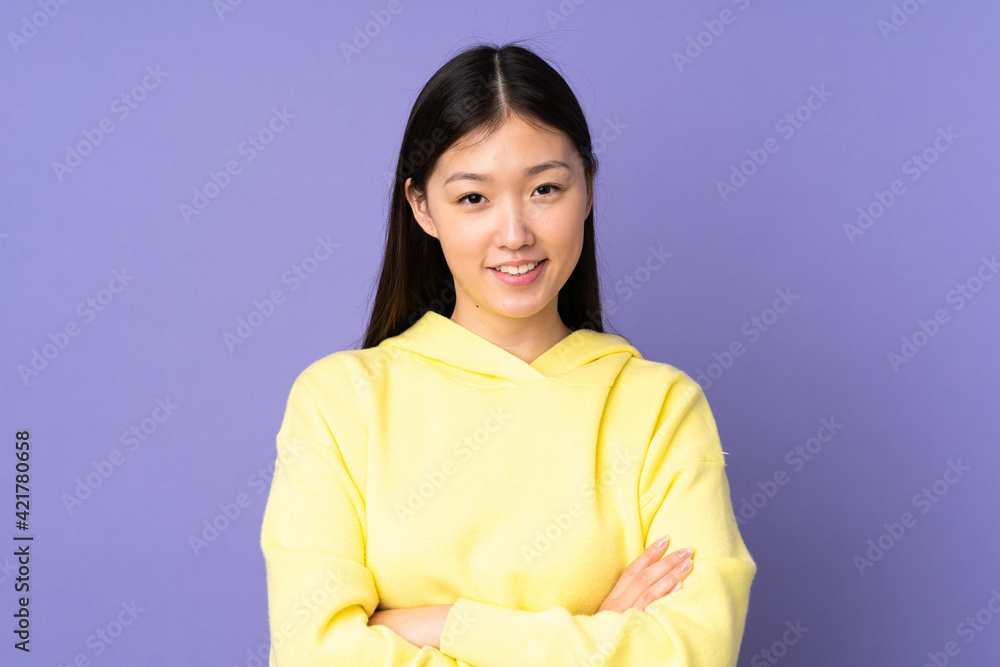 Young asian woman isolated on purple background keeping the arms crossed in frontal position Young asian woman isolated on purple background keeping the arms crossed in frontal position
