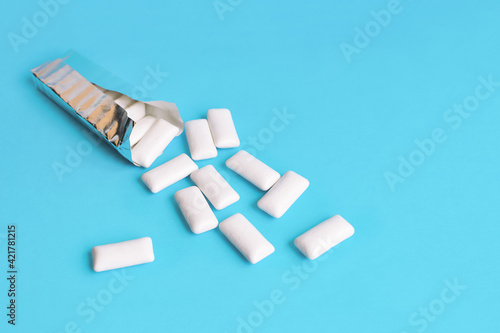 Mint chewing gum in the shape of a pillow on a blue background