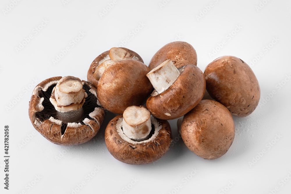 Fresh mushrooms on a light background. Brown champignons. Bunch of mushrooms.