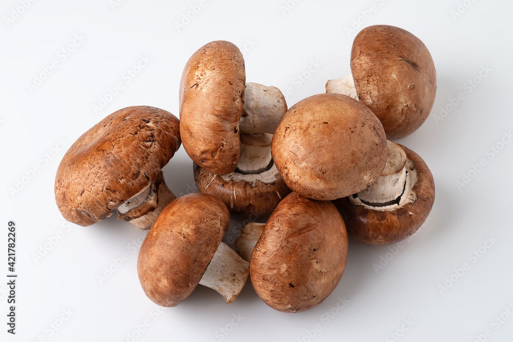 Fresh mushrooms on light background. Top view of brown champignons. Pile of mushrooms. Fresh mushrooms on light background. Top view of brown champignons. Pile of mushrooms.