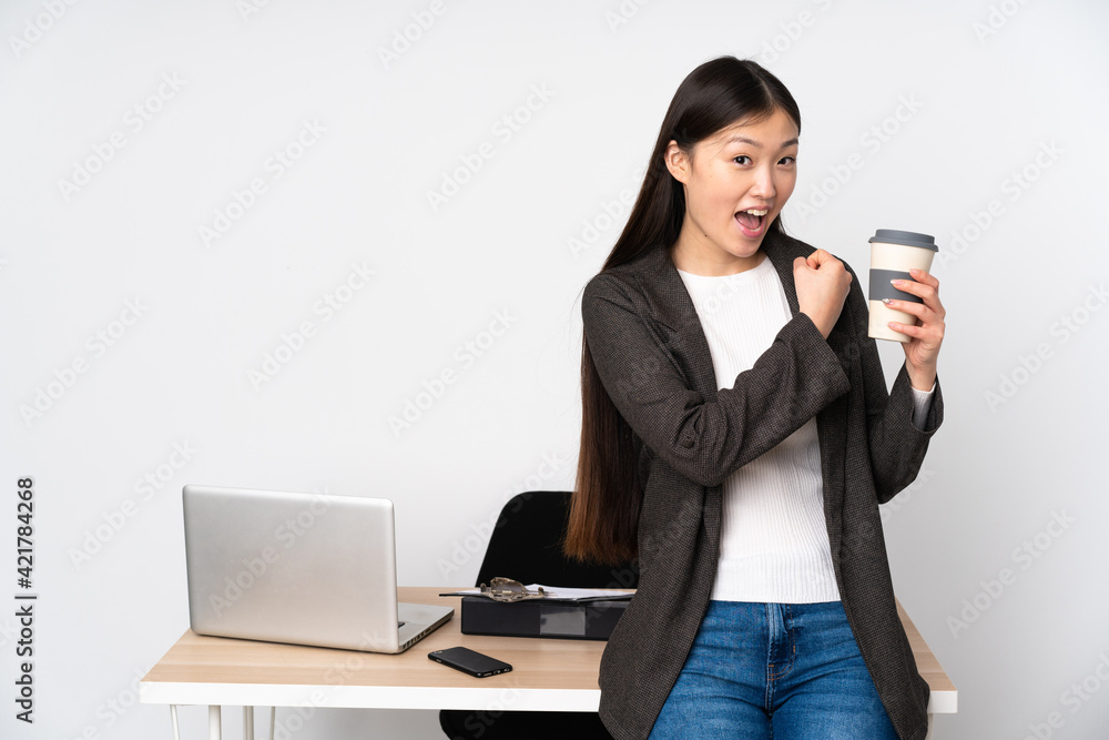 Business asian woman in her workplace isolated on white background celebrating a victory Business asian woman in her workplace isolated on white background celebrating a victory
