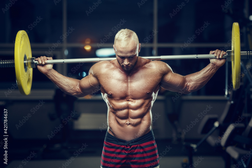 fit man training muscles at gym. fit man training muscles at gym.