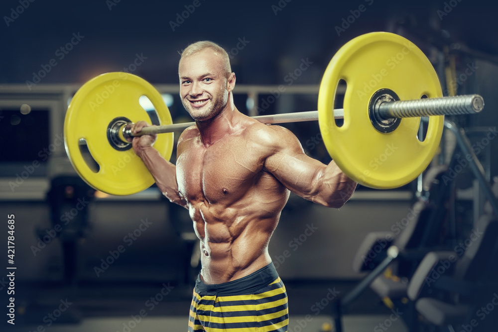 fit man training muscles at gym. fit man training muscles at gym.