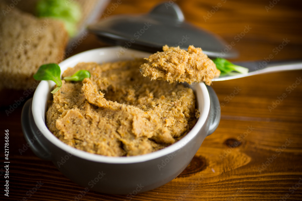homemade meat pate in a ceramic bowl on a wooden table homemade meat pate in a ceramic bowl on a wooden table