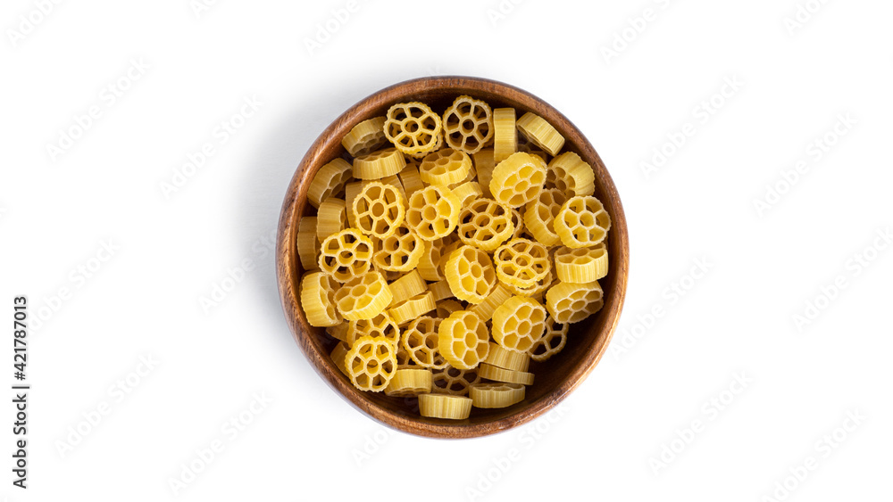 Rotelle pasta in wooden bowl isolated on white background.