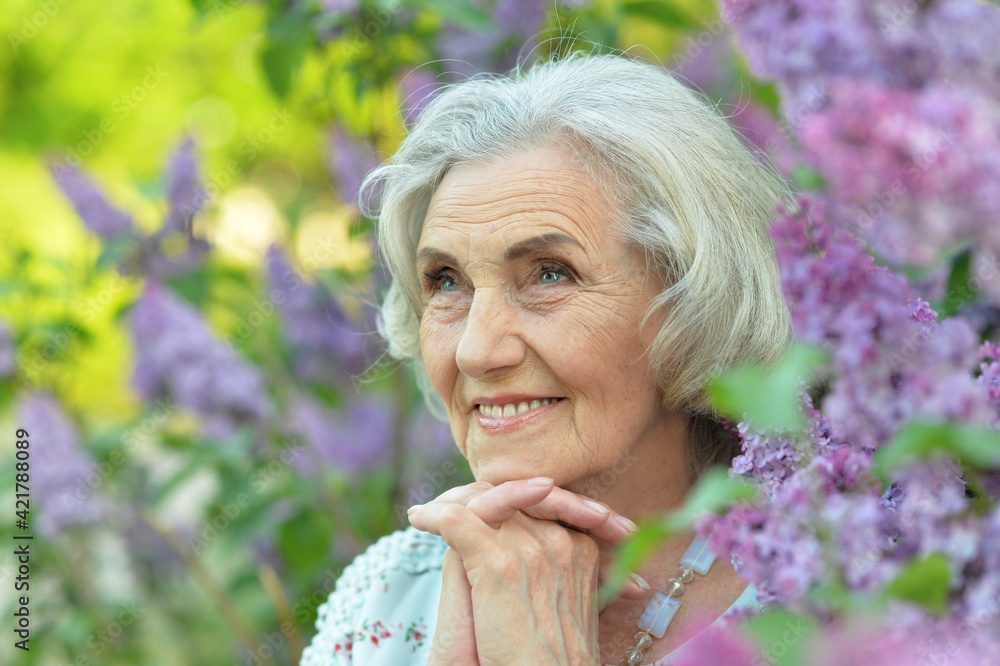 happy senior beautiful woman on lilacs background happy senior beautiful woman on lilacs background