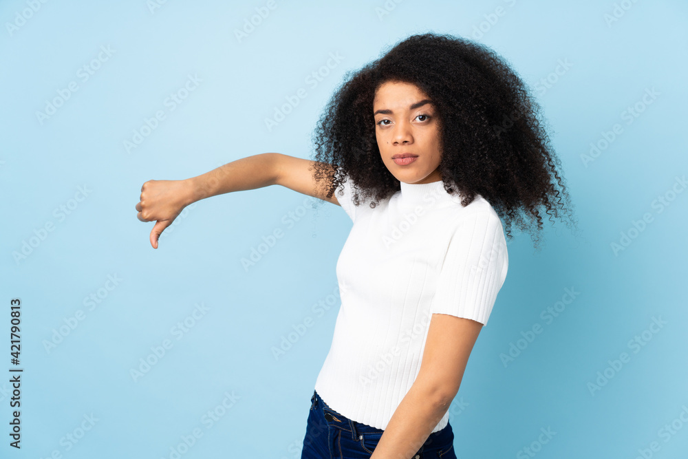 Young african american woman over isolated background showing thumb down with negative expression Young african american woman over isolated background showing thumb down with negative expression