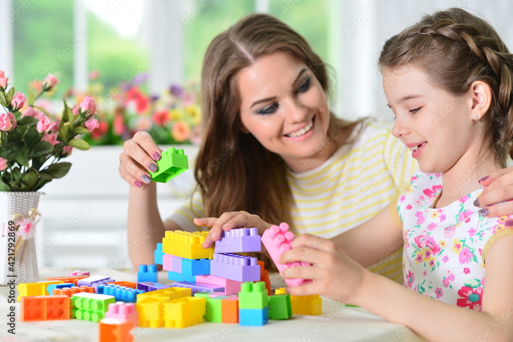 girl with mother playing with colorful plastic blocks girl with mother playing with colorful plastic blocks