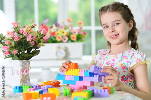  girl playing with colorful plastic blocks